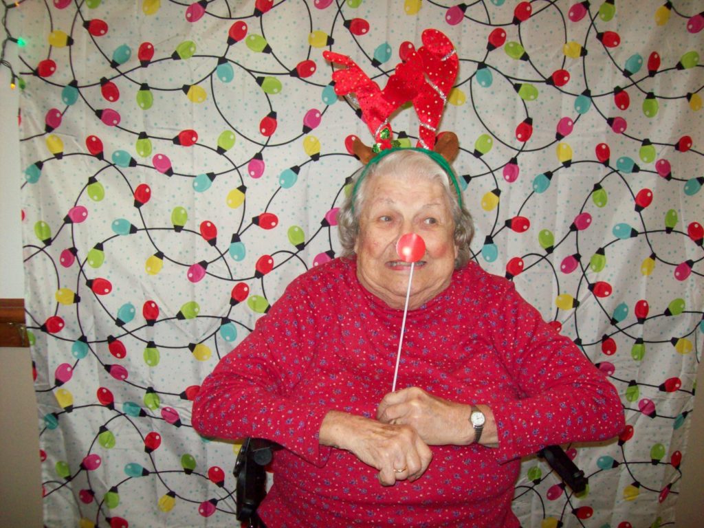 Beautiful elderly resident celebrating Christmas at Adams House Assisted Living party