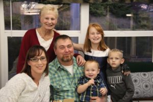 Smiling resident and family member enjoy Thanksgiving at Adams House Assisted Living in Myrtle Creek, Oregon